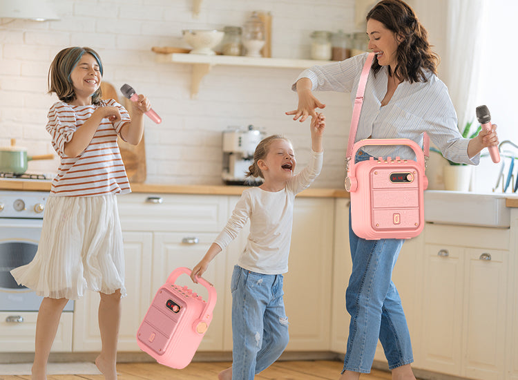 Girls are carrying JYX TX02 portable karaoke machine with 2 wireless microphones by handle and shoulder strap