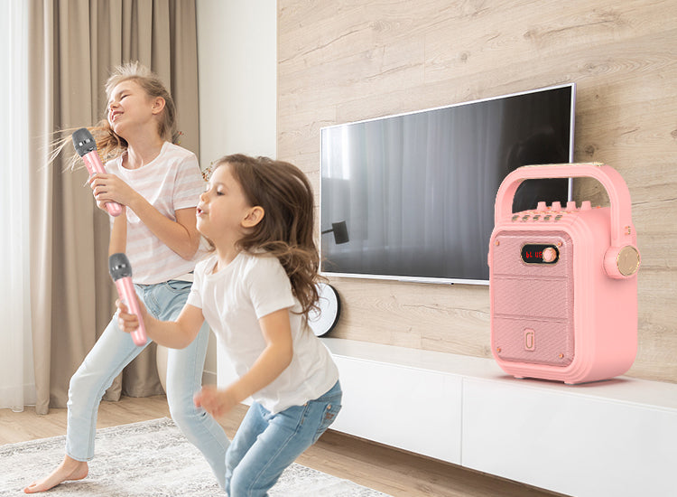 Two girls are singing with JYX TX02 karaoke machine in pink wih two wireless microphones