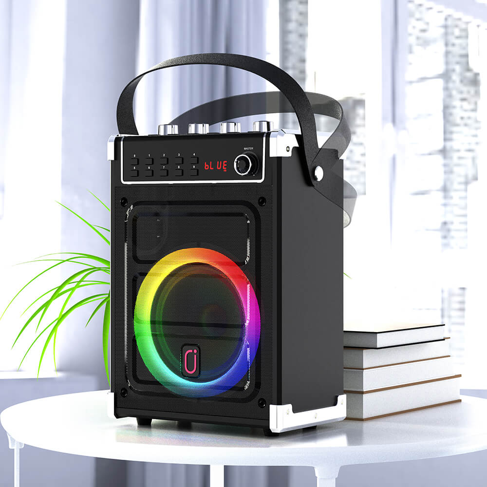 JYX 69BT portable karaoke speaker displayed on a white table, highlighting its swivel handle and removable carrying design for convenient transport.