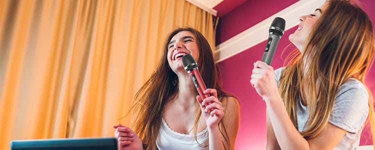 two girls singing with JYX wireless microphones